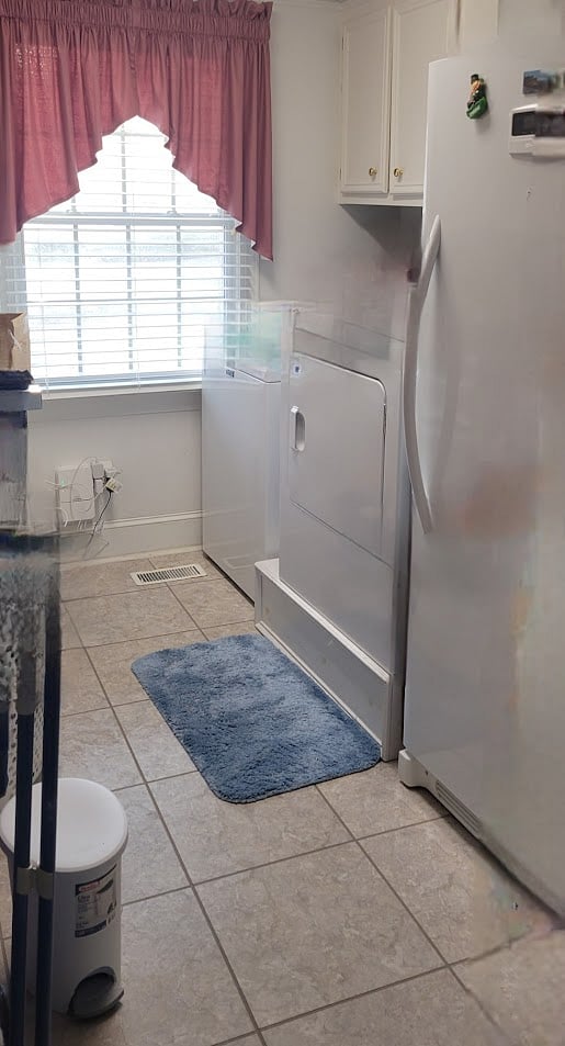 Roomy Laundry room with a seperate sink and a large freezer.