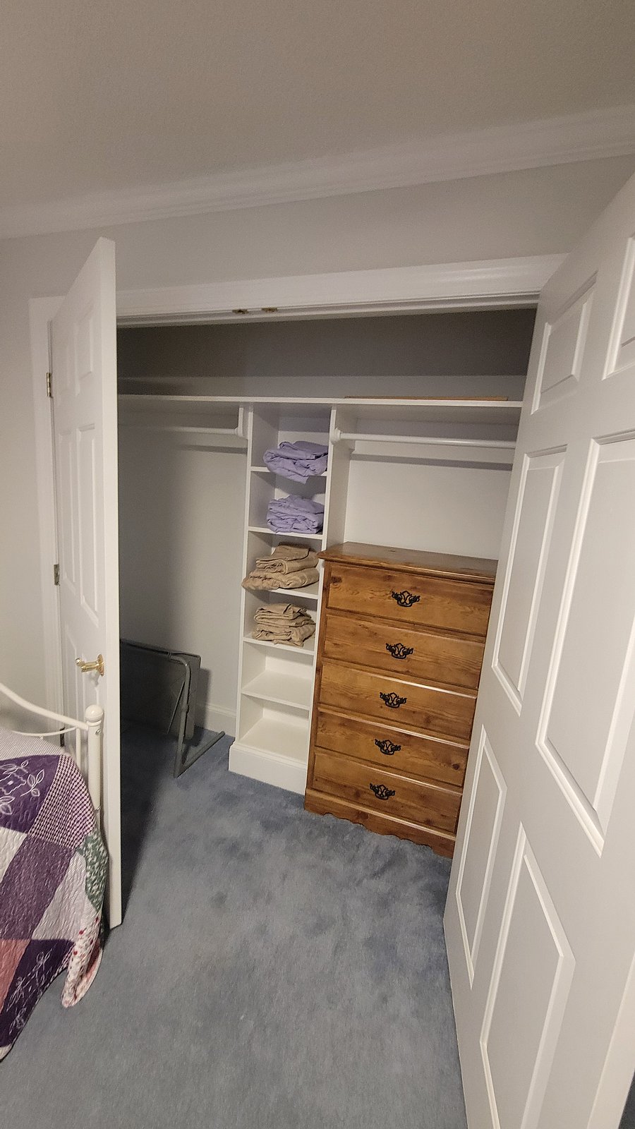 Spacious closet with a chest of drawers for additional storage 