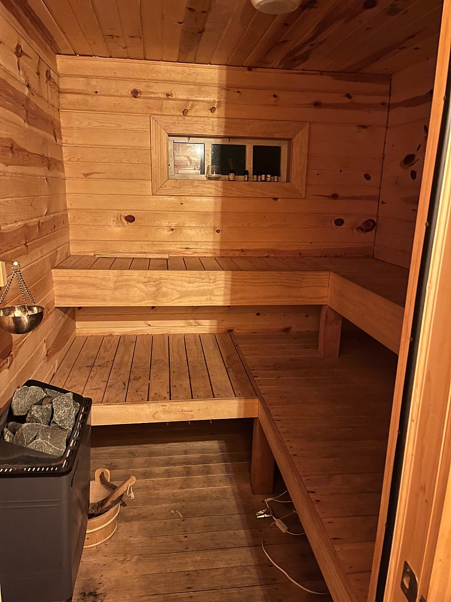 Sauna interior. Electric heater starts with the push of a button and heats in 15 minutes. Can fit 8-10 but not too big for 1!