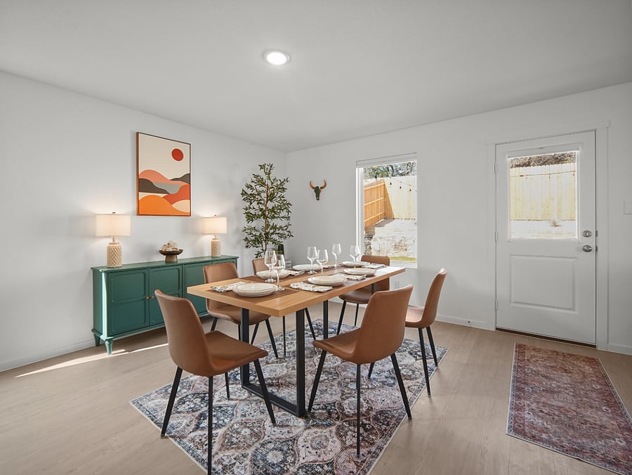 Defined yet open, the dining area flows effortlessly toward the backyard retreat  offering natural light, space to gather, and a peaceful outdoor view.