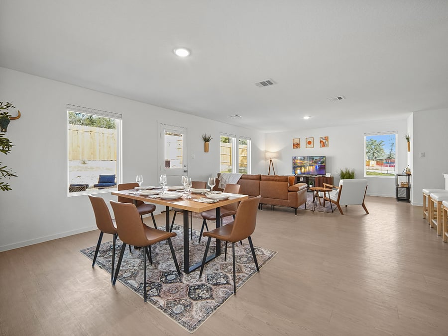 The openness of the downstairs brings together the elegant dining area, breakfast bar, living room, & game table  offering ample space to entertain or the perfect closeness to relax and enjoy your favorite show.