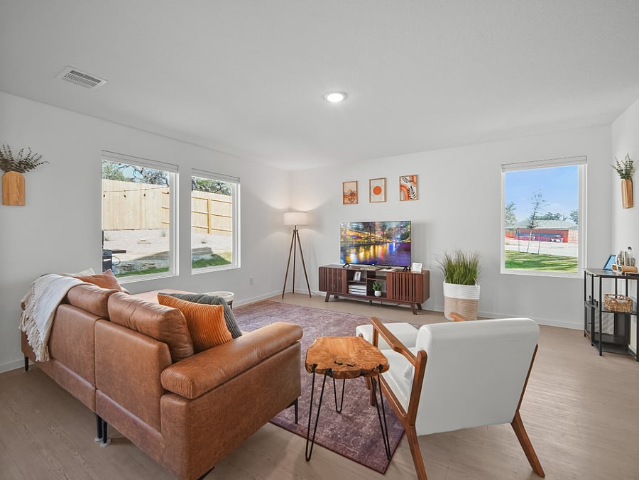 Framed by picture windows, the living room is filled with natural light and peaceful views of the backyard retreat and the front yards 70-year-old Live Oak.