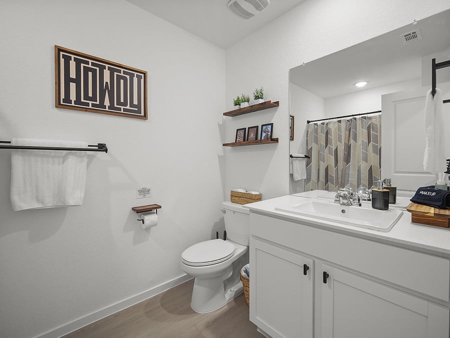 Western-themed details add character to this upstairs guest bath, featuring a versatile bathtub-shower combo perfect for unwinding or quick refreshes.