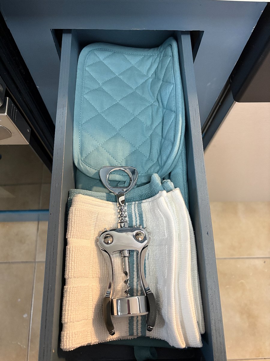 Corkscrew and pot holders included in kitchen