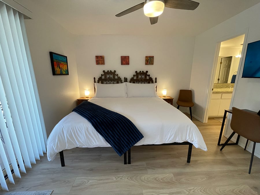 Secondary bedroom downstairs in king bed configuration with en suite full bathroom