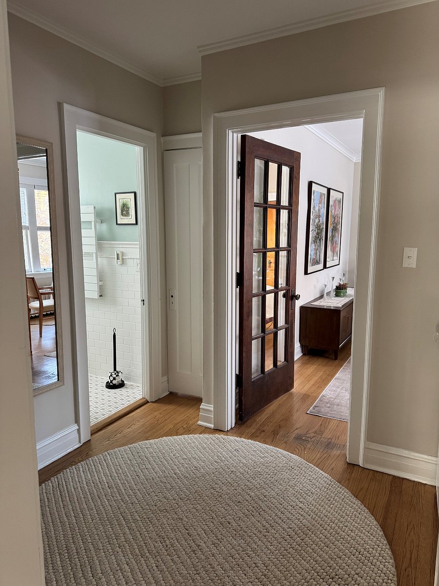 Interior hallway leading to from dining and bathrooms to kitchen.