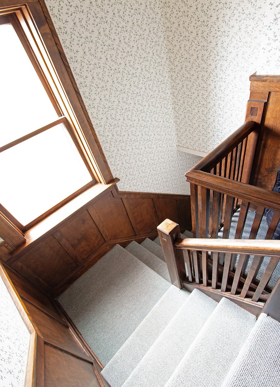 Interior front stairway off unit 2 apartment.