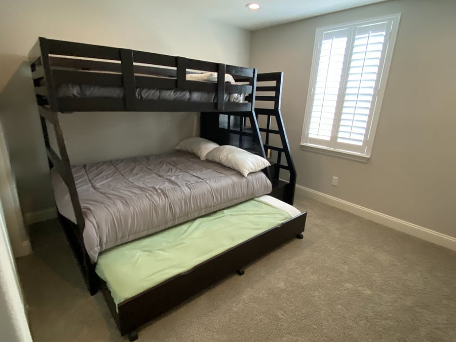 Middle bedroom has bunk bed with double, twin, and twin beds