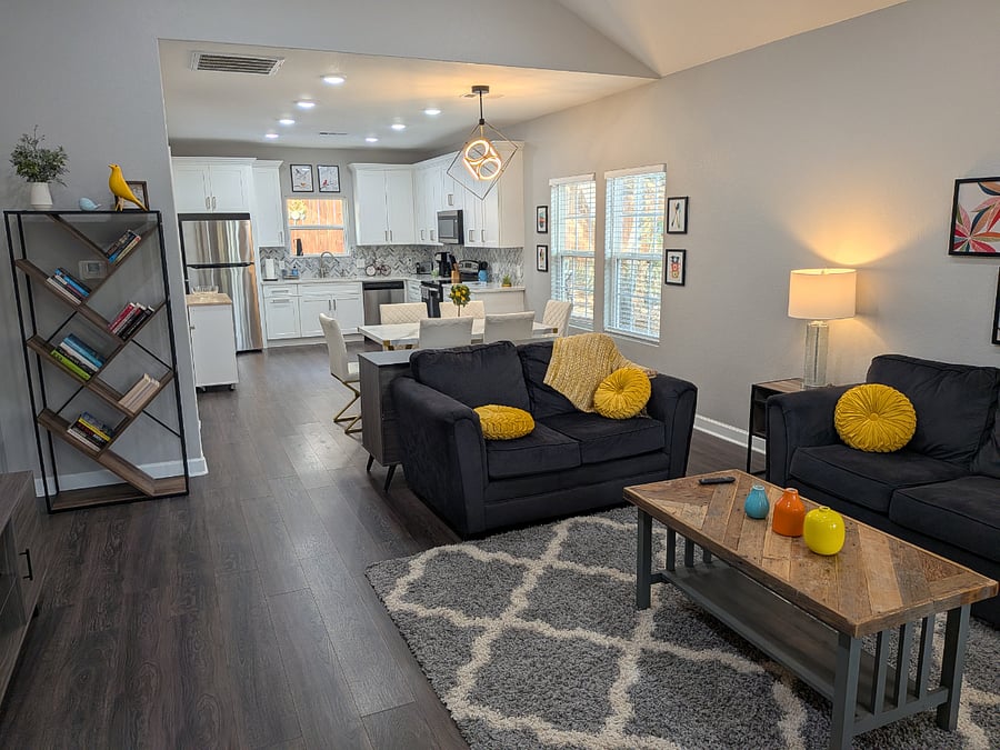 The open and airy floorplan leads from the living room to the dining and into the chef's kitchen.