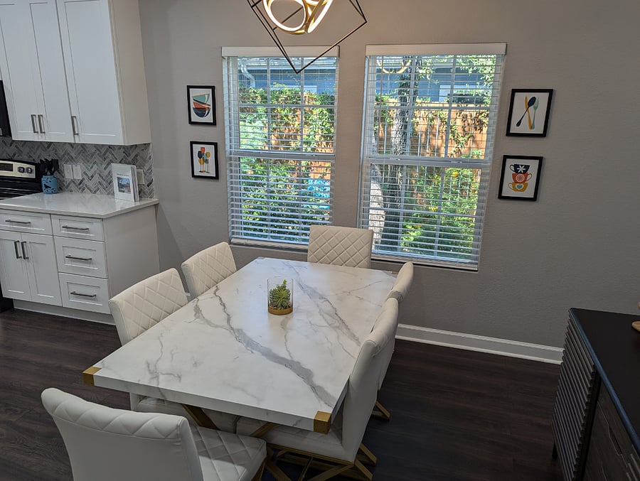 The dining table looks out on the colorful garden.