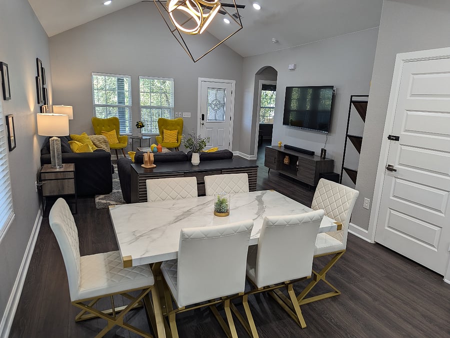 A modern dining table has six comfortable chairs where you can eat your meals.