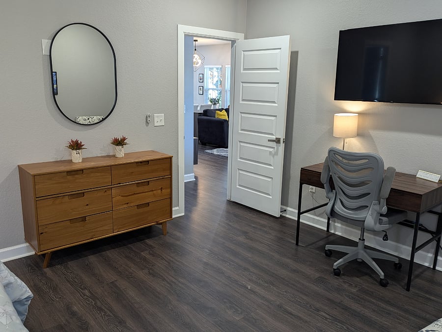The master bedroom features a 55" TV and work area for home office needs.
