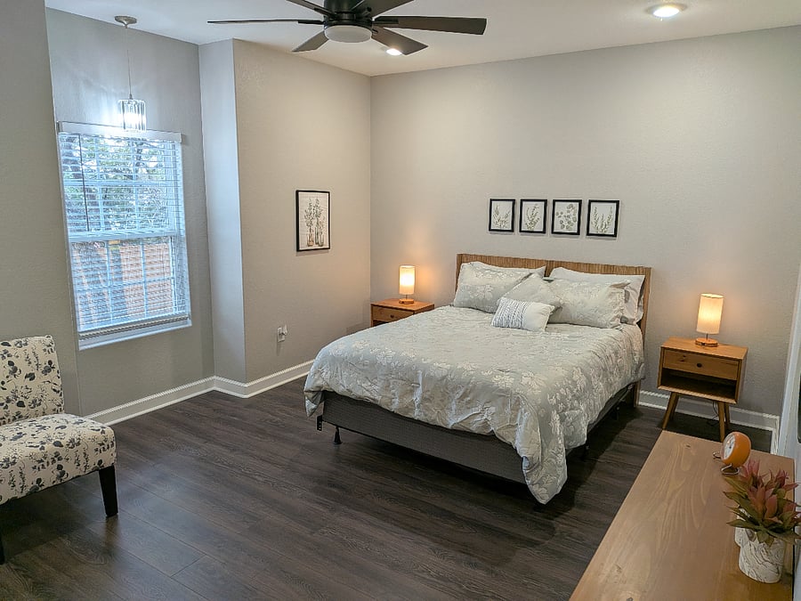 The master bedroom features a queen size bed with comfortable linens, two nightstands, and a full size dresser.
