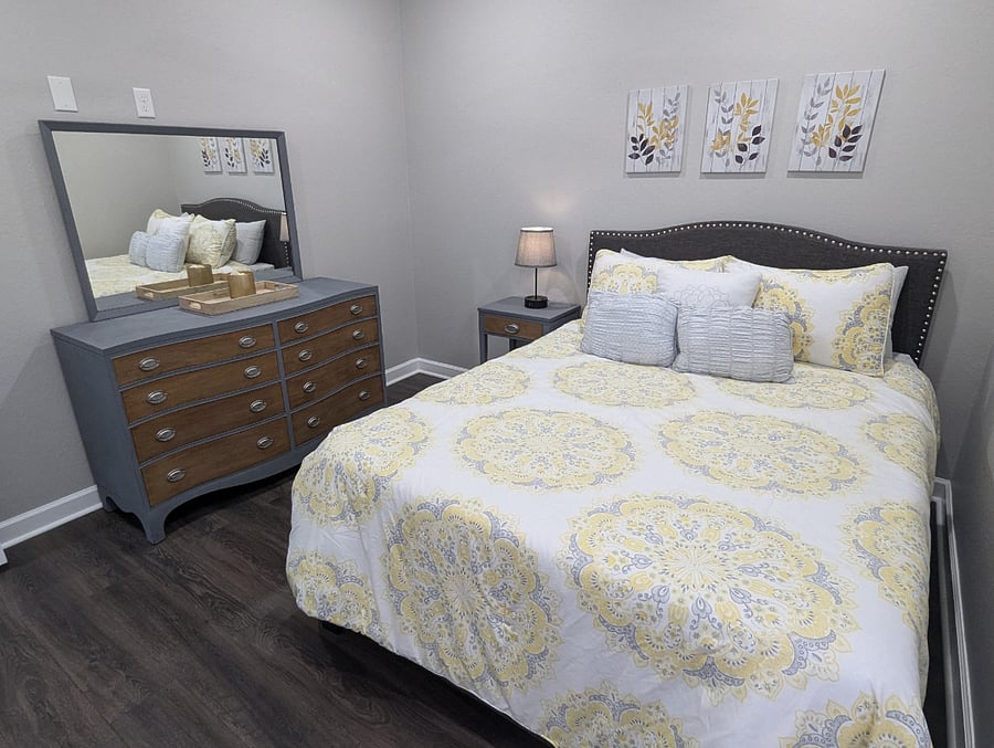 The second bedroom features a queen size bed with comfortable linens, a nightstand, full size dresser and large closet.