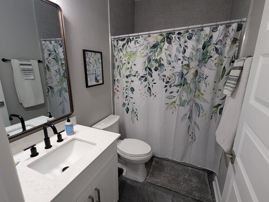The second bathroom includes one sink and a full bathtub.