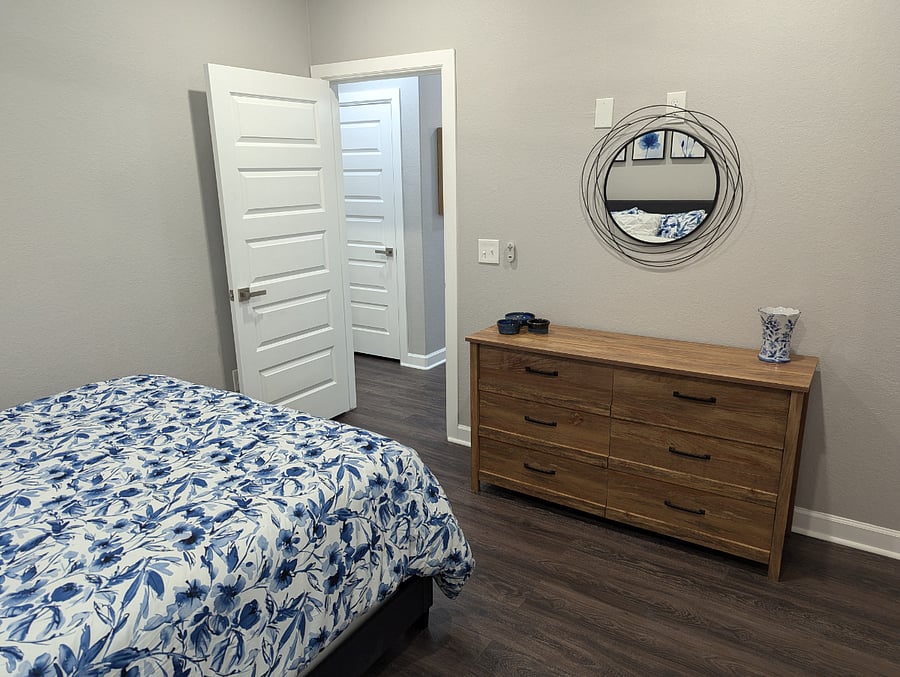 The third bedroom features a queen size bed with comfortable linens, a nightstand, full size dresser and spacious closet.
