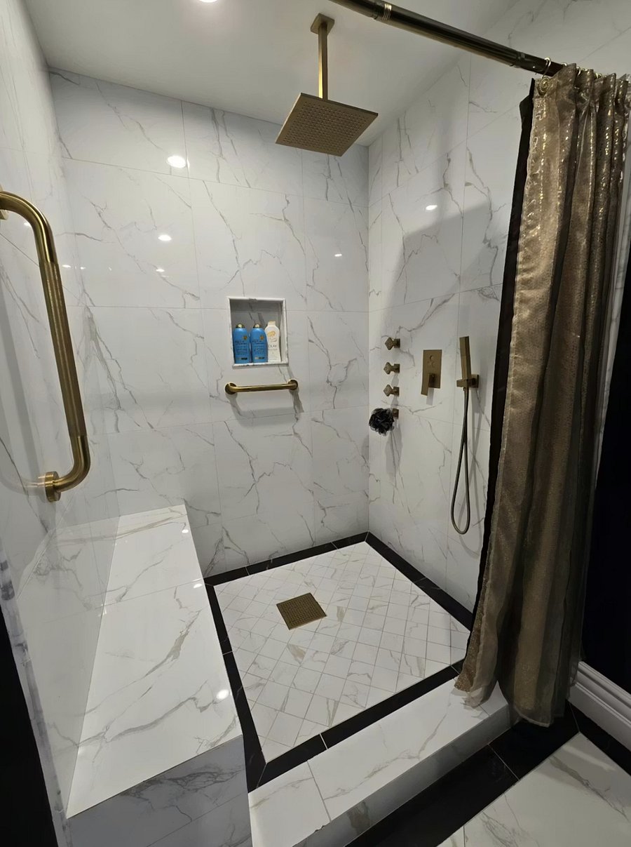 Luxury shower featuring overhead rain shower, handheld wand, and body sprays.