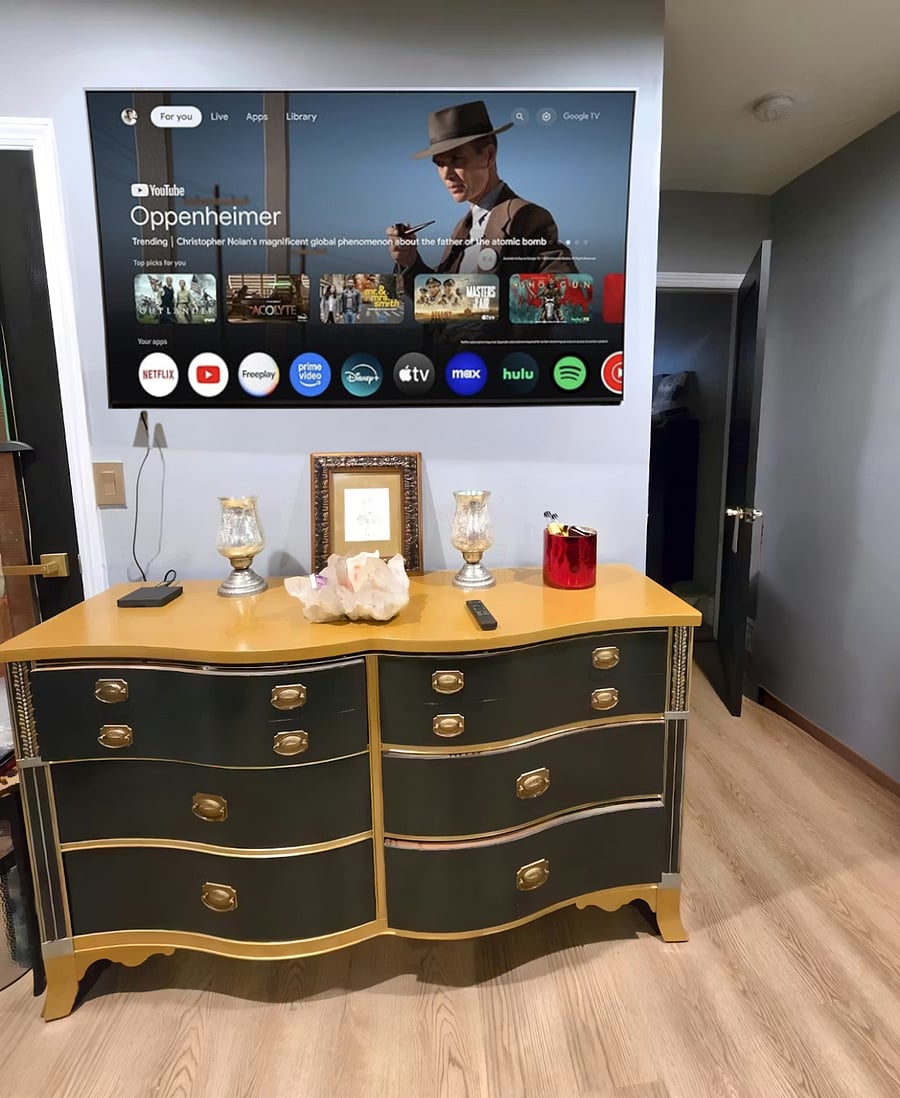 California King bedroom with solid wood drawer units offering ample storage, closet space, and a 65 smart TV for comfortable evenings.