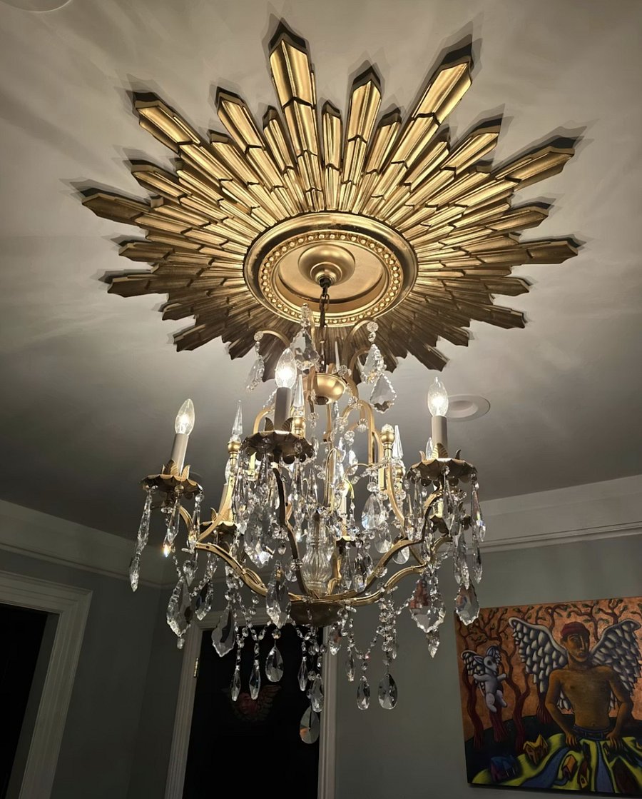 Elegant dining room chandelier with warm ambient lighting. Dedicated workspace with high-speed Wi-Fi near Netflix and studios.