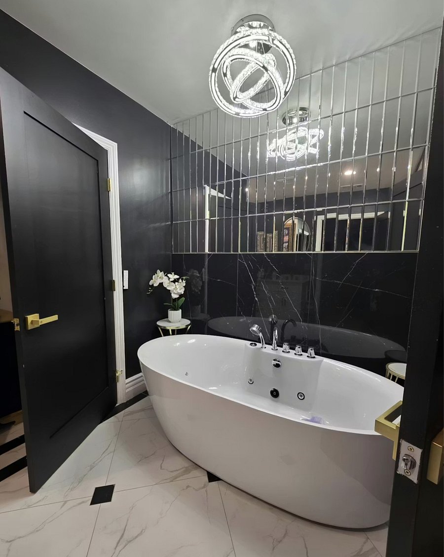 Spa-style bathroom featuring a deep soaking jacuzzi tub and two separate water closets with bidets.