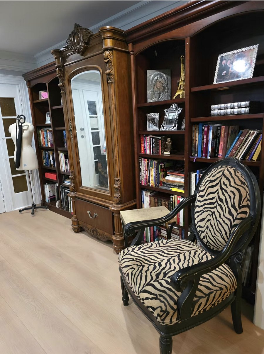 Private library with built-in bookshelves and an elegant mirrored wardrobe closet.