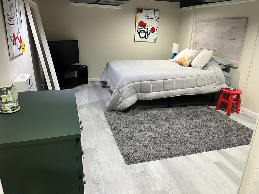 Large bedroom with dresser, smart TV