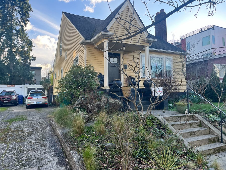 Street view of full house, apartment entrance along driveway