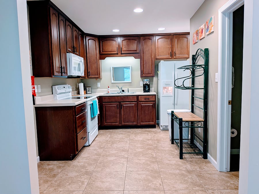Kitchen
with full-size fridge, oven range, microwave, coffee maker, pantry closet. Stocked with dishes, utensils, cookware