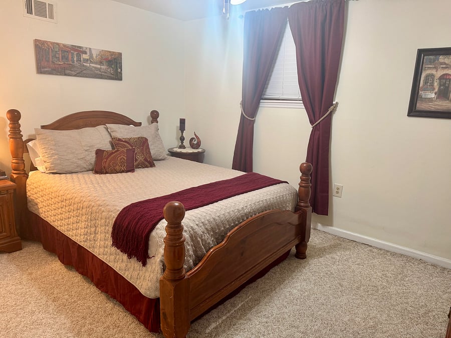 Queen bed with one comforter and room darkening curtains