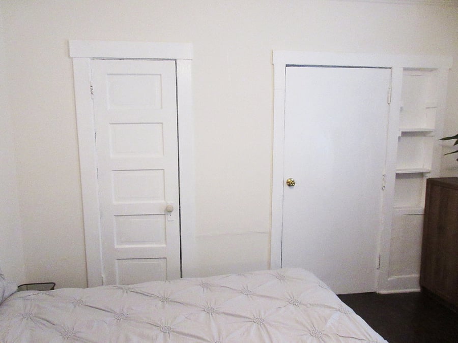 Private bedroom, POV from entrance door. Pictured are closet door (left), private entrance from exterior (right).