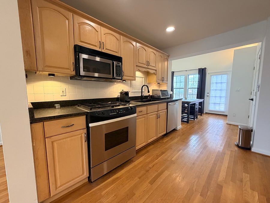 Kitchen with stainless steel appliances - stove, dishwasher, microwave