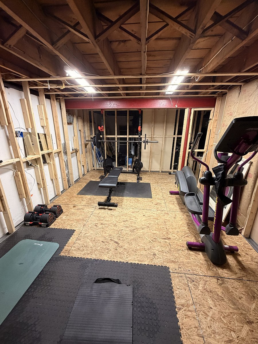 Gym with squat/bench rack, free weights, bar bells, adjustable dumbbells, elliptical, stationary bike.