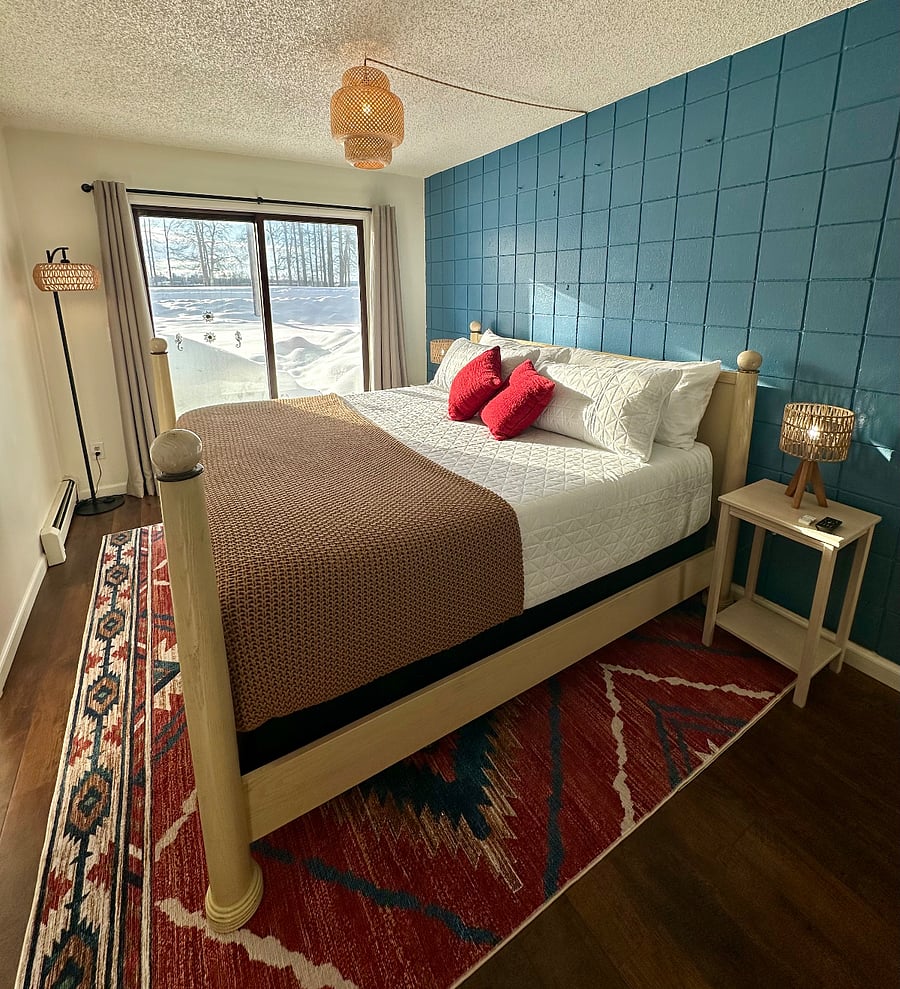 Bedroom (ground-level, facing Lake Hood) with the world's comfiest King bed, crisp quilted bedding, soft cotton sheets, cozy blanket, blackout curtains, and plenty (four) of pillows for a great sleep!