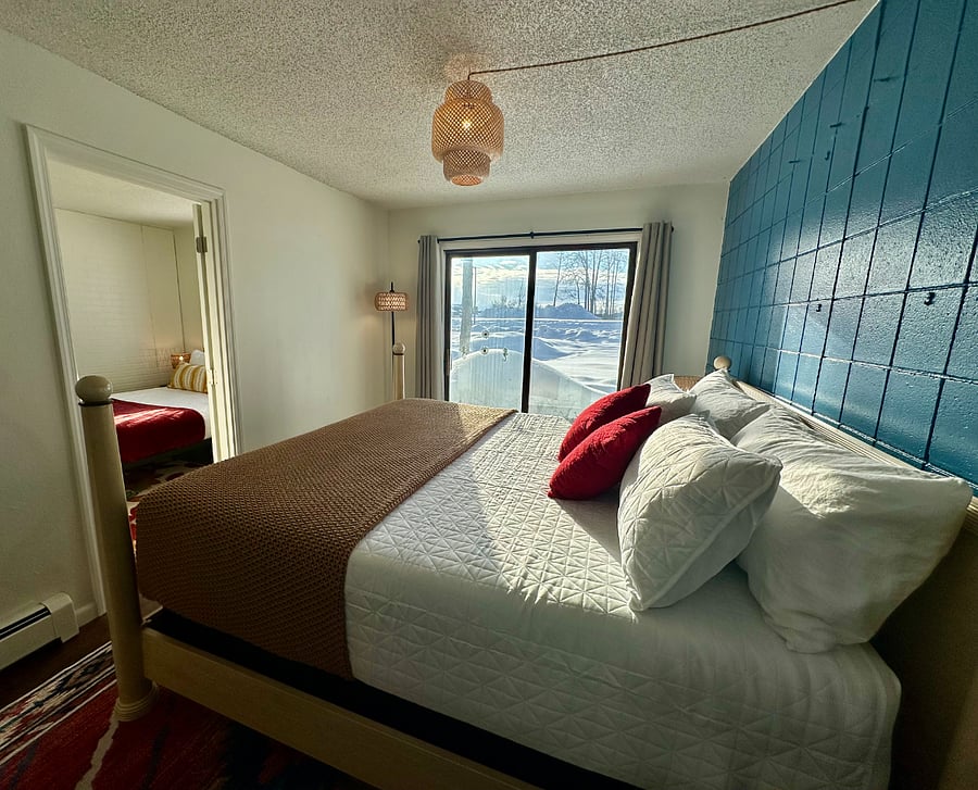 Another view of the bedroom with the King bed, now showing outdoor area facing Lake Hood and access door to "annex" third bedroom with Queen bed.