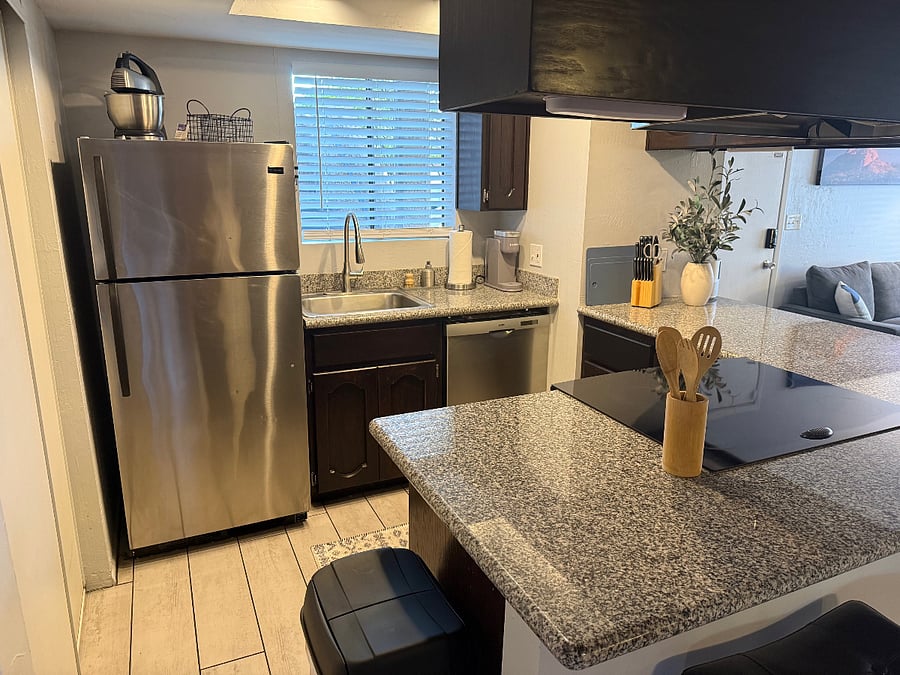Kitchen w/dishwasher, full size stove & oven, microwave, stackable washer/driver in pantry