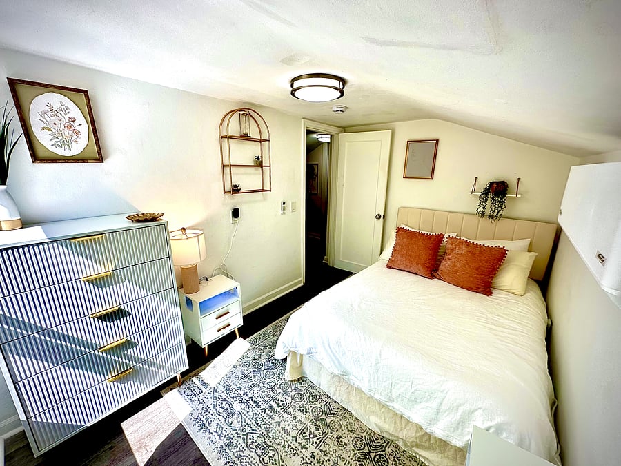 Bedroom 2 - $1,000/month. Cozy fully furnished private upstairs room with a full-size bed, dresser, individual room lock, A/C, blackout curtains, Wi-Fi, and utilities included. Ideal for one guest seeking comfortable temporary housing.