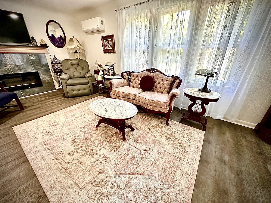 Shared Living Room - Comfortable main-level seating area available to guests outside weekday adult day program hours, with plenty of natural light and space to relax.