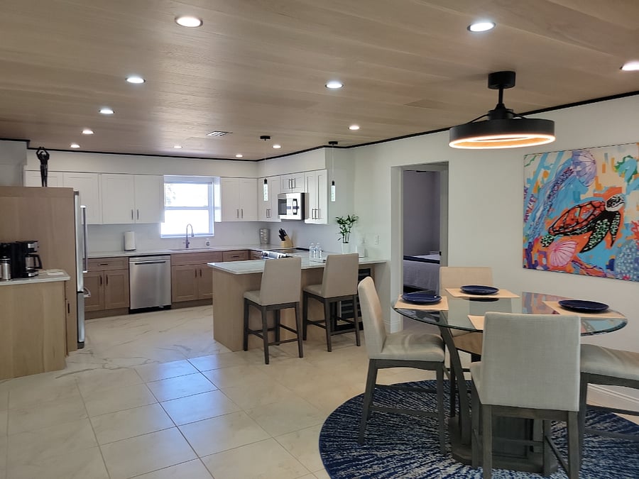 Kitchen and four top showing 10" wood plank ceiling