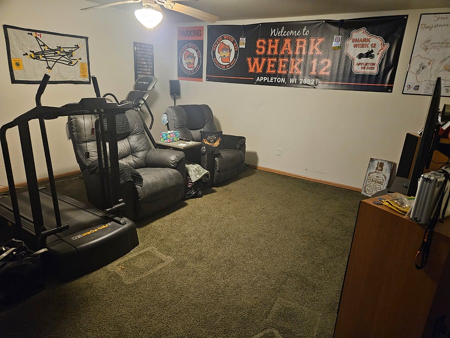 Shared downstairs living room area with 2 recliners, 65" Smart TV, and surround sound system.