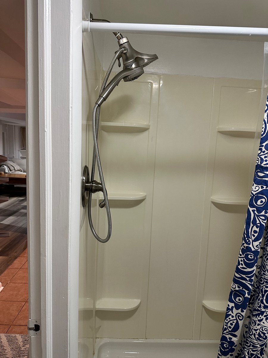 Extra large shower with hand held and stationary shower heads. 