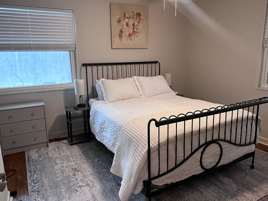 Primary Suite: Features a plush Queen bed, Smart TV, and a high-end noise machine to ensure a restful night's sleep in the heart of the city.