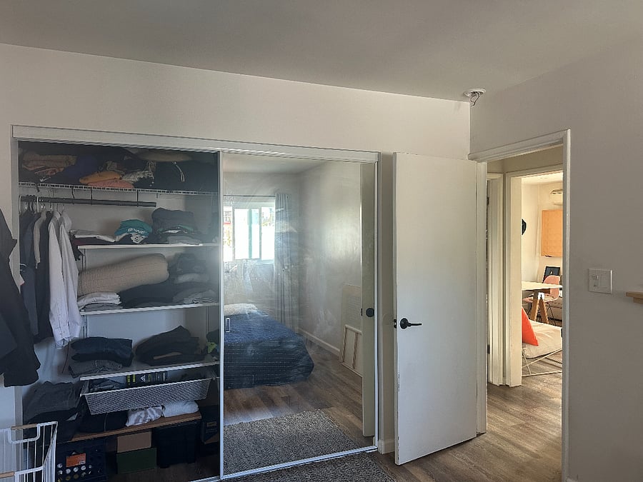 Primary bedroom with large closet and shelving