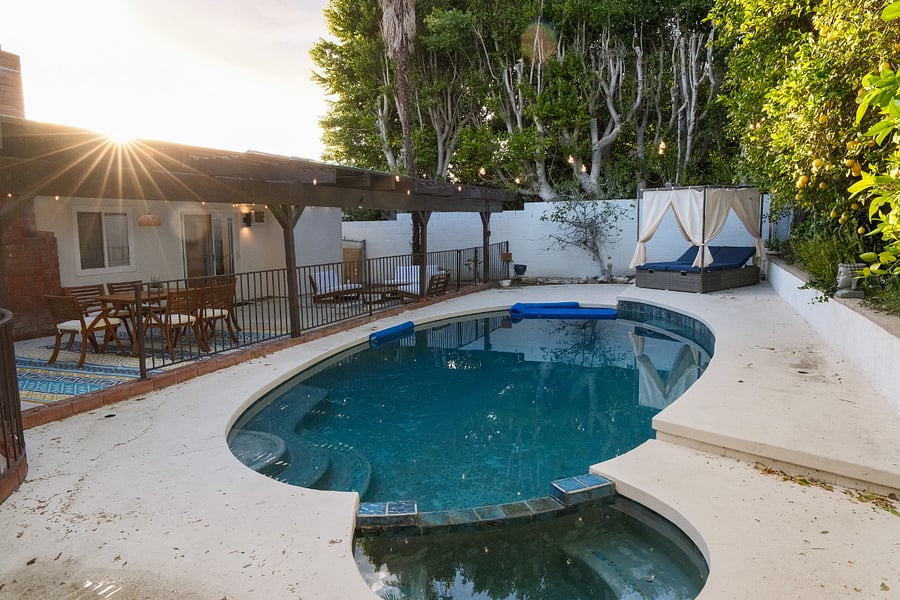 Large pool with light strings above for a cozy evening