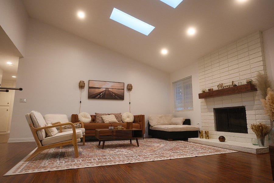 Living room with a lounge chair and wood burning fire place  and smart TV