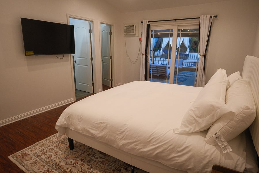 Primary bedroom with walk in closet with a safe.