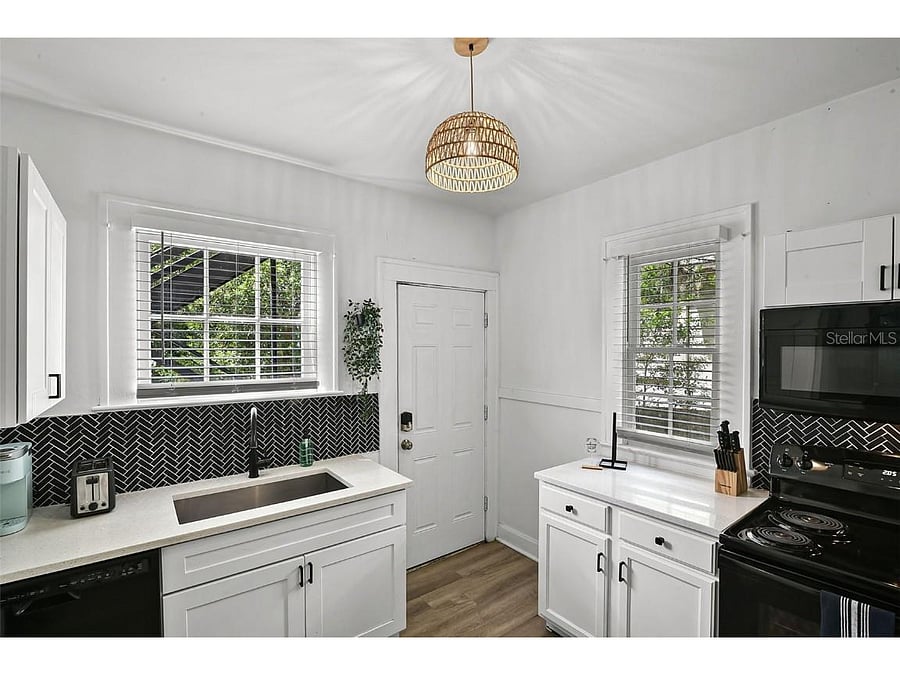 Kitchen with full size fridge, microwave, oven, and small dishwasher
