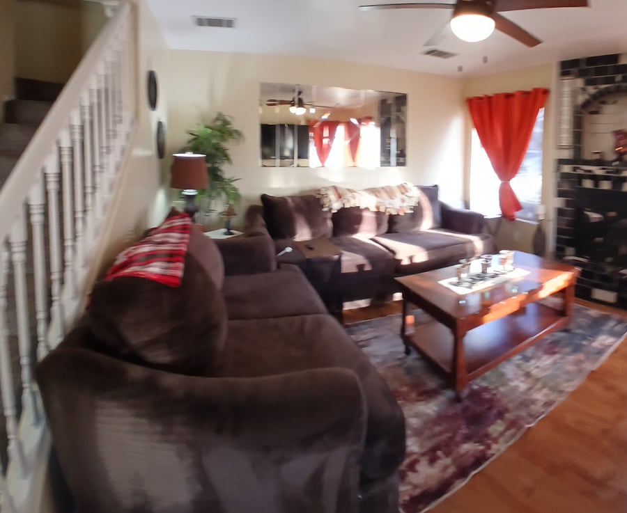 Comfy cozy living room with great day time lighting with mini blinds and black out curtains for added privacy