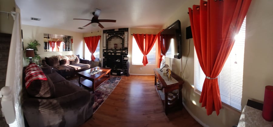 Gorgeous relaxing living room with tv and black out curtains 