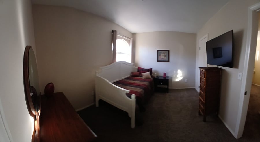 3rd bedroom day bed tv with black out curtains with walkin closet