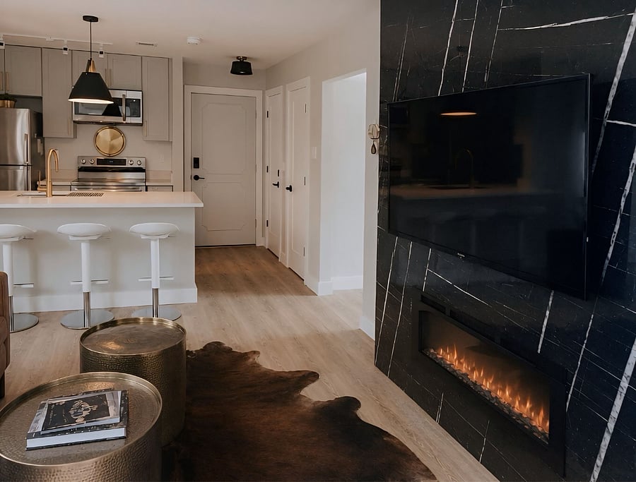 Open-concept living, dining & chefs kitchen with Smart TV and designer finishes
